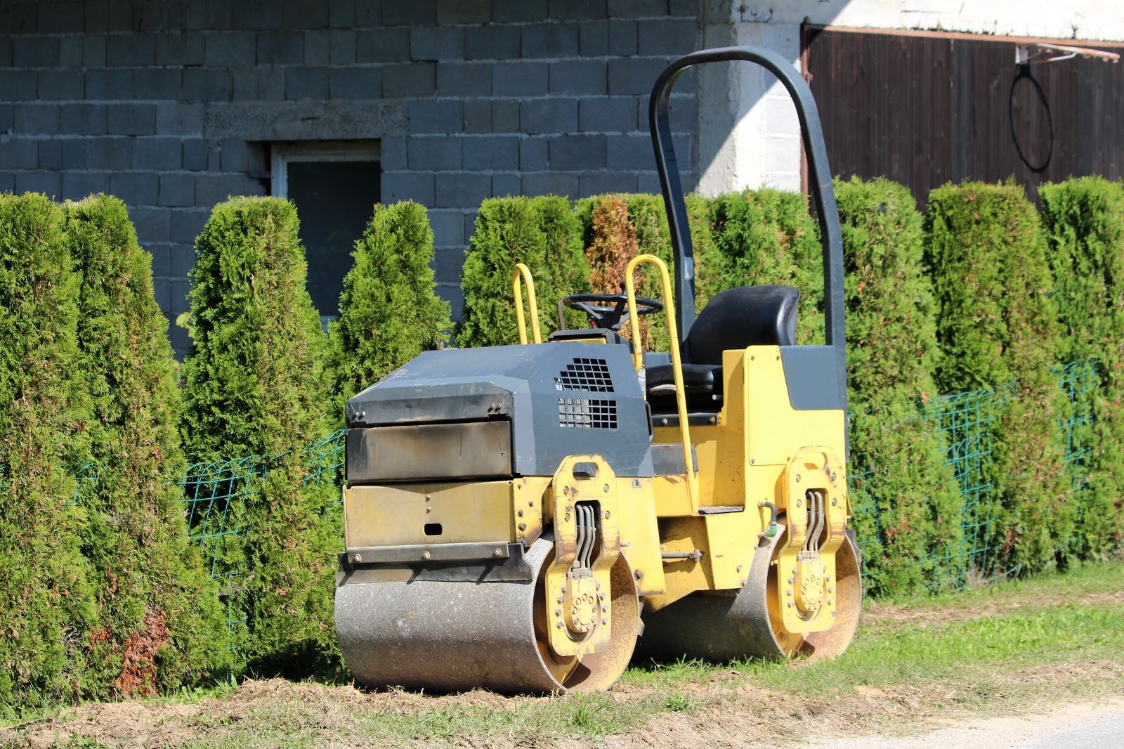 Yellow vibratory roller on a backyard
